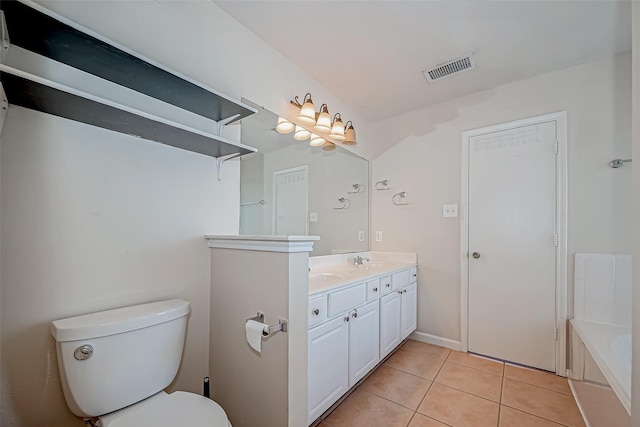 bathroom featuring toilet, visible vents, a bath, tile patterned floors, and double vanity