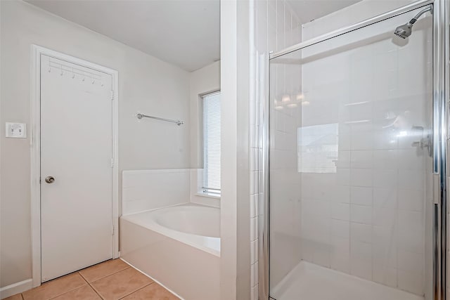 bathroom with a stall shower and tile patterned flooring