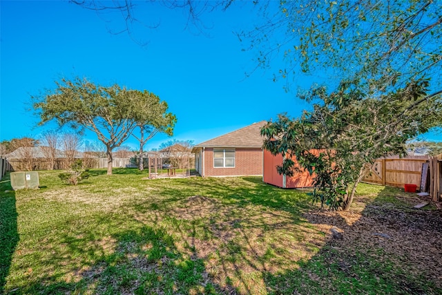 view of yard with a fenced backyard and an outdoor structure