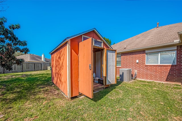 view of shed featuring cooling unit and fence