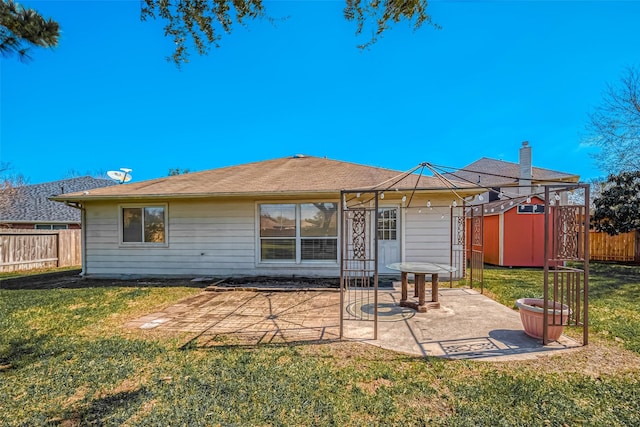 back of property featuring a patio area, a yard, and a fenced backyard