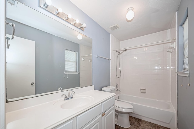 full bath with visible vents, toilet, vanity, tile patterned flooring, and shower / bathtub combination