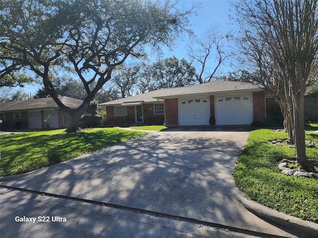 ranch-style house with a garage, driveway, brick siding, and a front yard