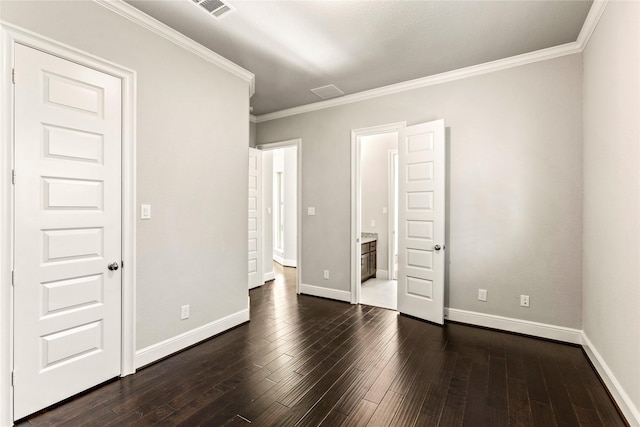 unfurnished bedroom with dark wood-style floors, visible vents, crown molding, and baseboards