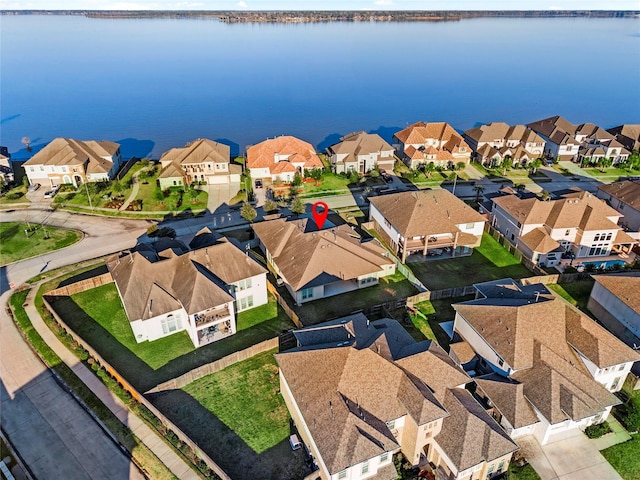 birds eye view of property featuring a water view and a residential view