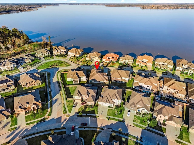 drone / aerial view with a water view and a residential view