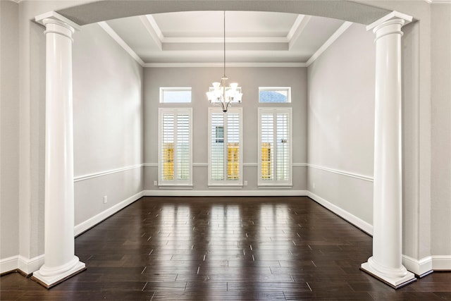 unfurnished dining area with arched walkways, a raised ceiling, dark wood finished floors, and ornate columns