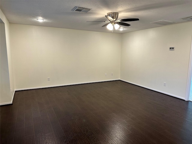 unfurnished room with a ceiling fan, baseboards, visible vents, and dark wood-style flooring