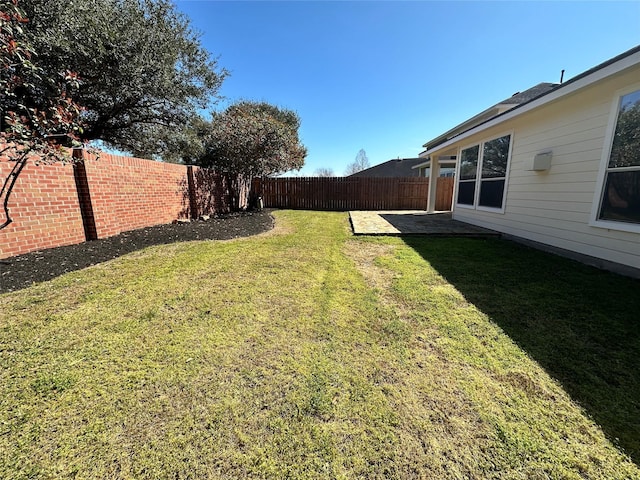 view of yard featuring a patio area and a fenced backyard