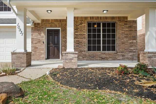 entrance to property with brick siding and a porch