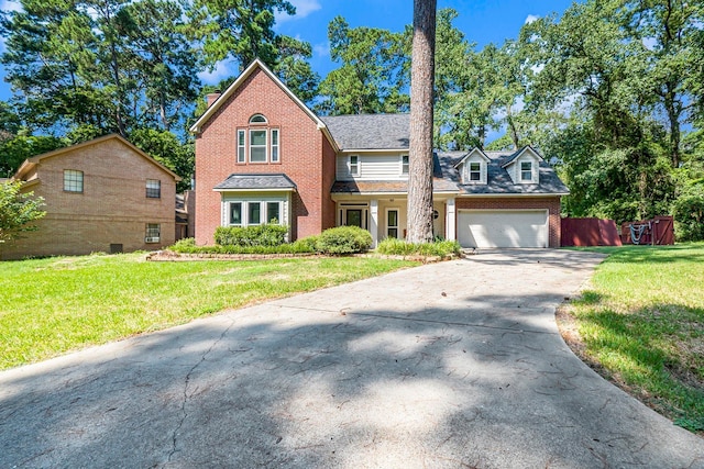 view of front facade with driveway, a garage, a chimney, a front lawn, and brick siding