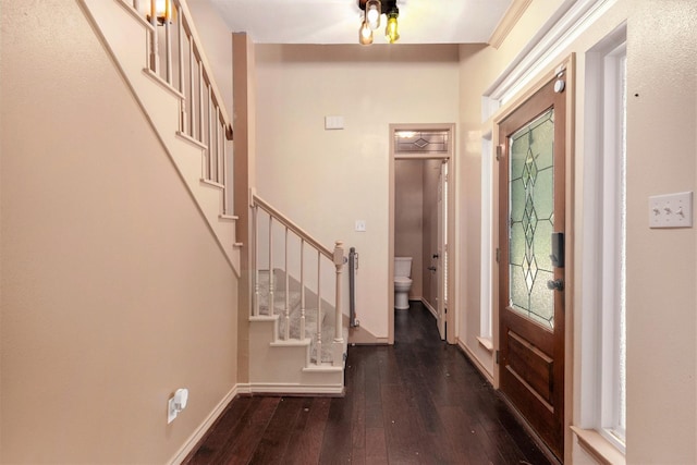 entryway featuring stairway, baseboards, and hardwood / wood-style flooring