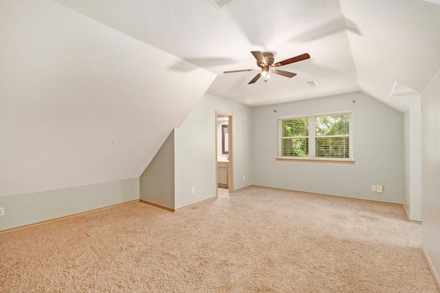 bonus room featuring a ceiling fan, lofted ceiling, carpet flooring, and baseboards