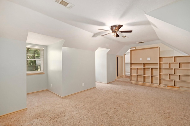 bonus room featuring lofted ceiling, ceiling fan, carpet floors, visible vents, and baseboards