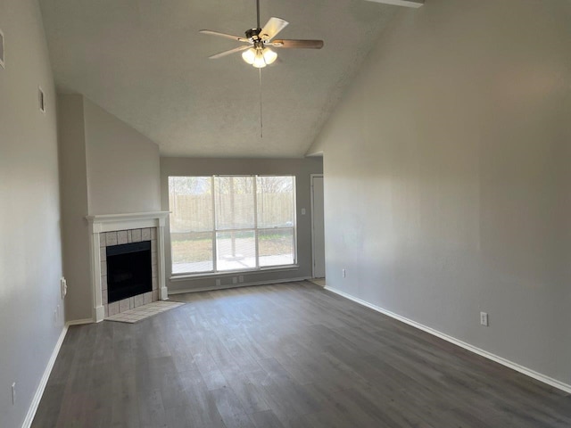 unfurnished living room featuring baseboards, visible vents, ceiling fan, dark wood-type flooring, and a fireplace