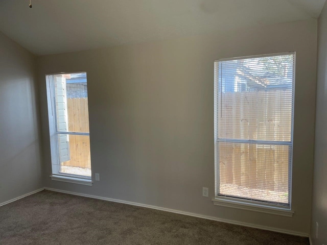 unfurnished room with carpet floors and baseboards