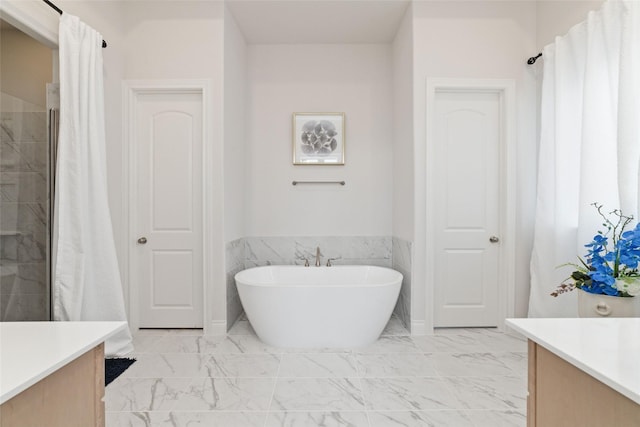 full bath featuring marble finish floor, a soaking tub, vanity, and a tile shower