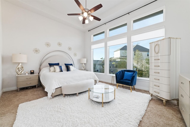 carpeted bedroom with a ceiling fan and baseboards