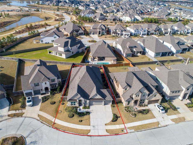 drone / aerial view with a water view and a residential view