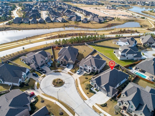 bird's eye view featuring a water view and a residential view