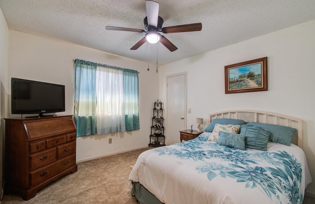 bedroom featuring carpet flooring, ceiling fan, a textured ceiling, and baseboards