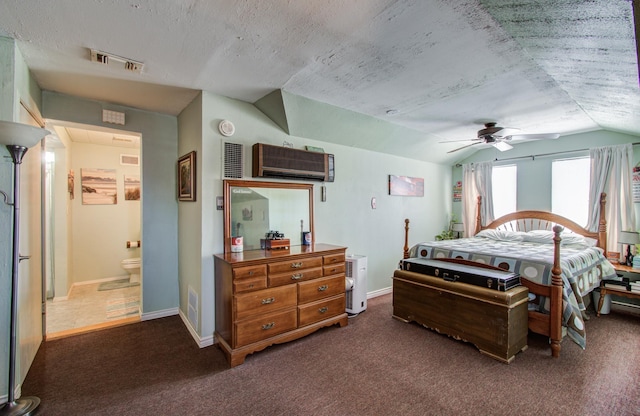 bedroom featuring lofted ceiling, a wall unit AC, dark carpet, and visible vents