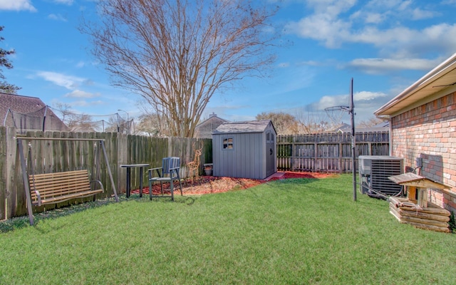 view of yard with an outbuilding, central AC, a shed, and a fenced backyard