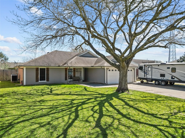 ranch-style house featuring an attached garage, driveway, fence, and a front yard