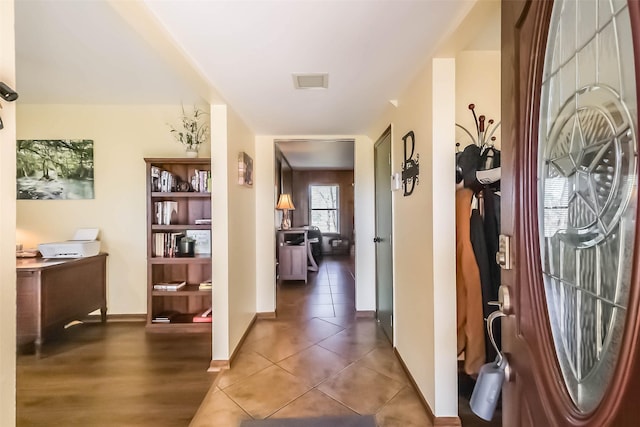 entryway featuring tile patterned flooring, visible vents, and baseboards