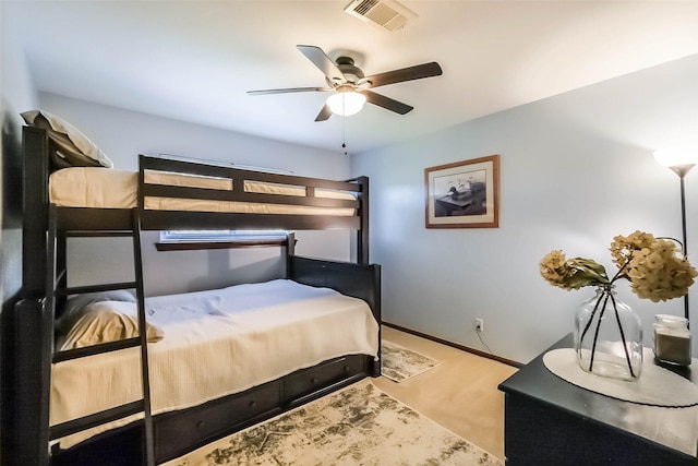 carpeted bedroom with baseboards, visible vents, and a ceiling fan