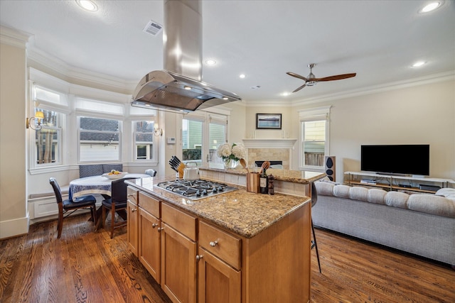 kitchen featuring open floor plan, visible vents, stainless steel gas stovetop, and island range hood