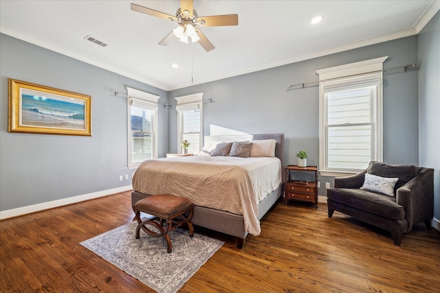 bedroom featuring visible vents, wood finished floors, and ornamental molding