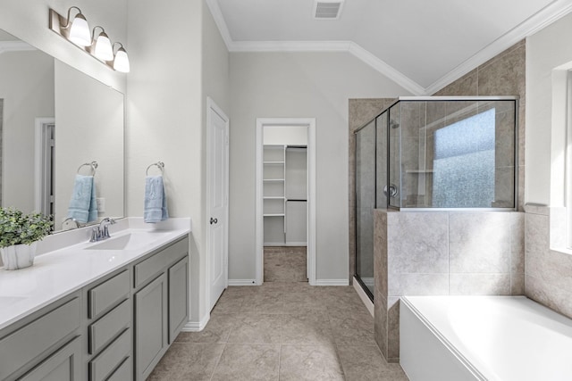 full bath featuring a stall shower, visible vents, ornamental molding, a walk in closet, and vaulted ceiling