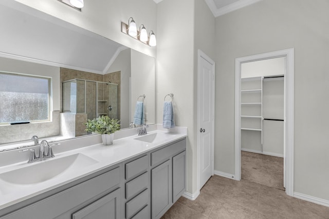 full bathroom featuring a stall shower, crown molding, a walk in closet, and a sink