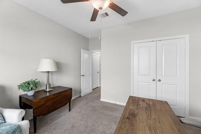 carpeted office with a ceiling fan, visible vents, and baseboards