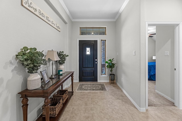 foyer entrance featuring light tile patterned floors, ornamental molding, and baseboards