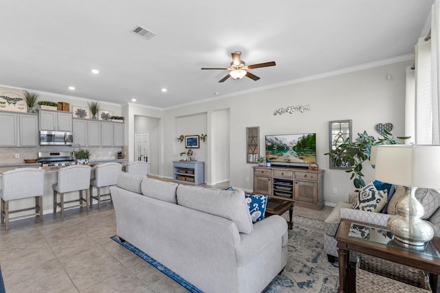 living area featuring crown molding, recessed lighting, visible vents, light tile patterned flooring, and ceiling fan