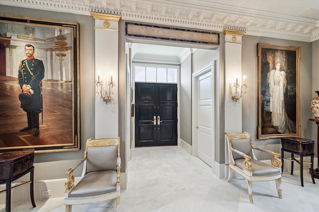 entrance foyer featuring baseboards, visible vents, and crown molding