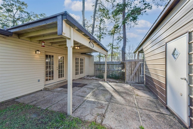 view of patio / terrace featuring french doors, fence, and a gate