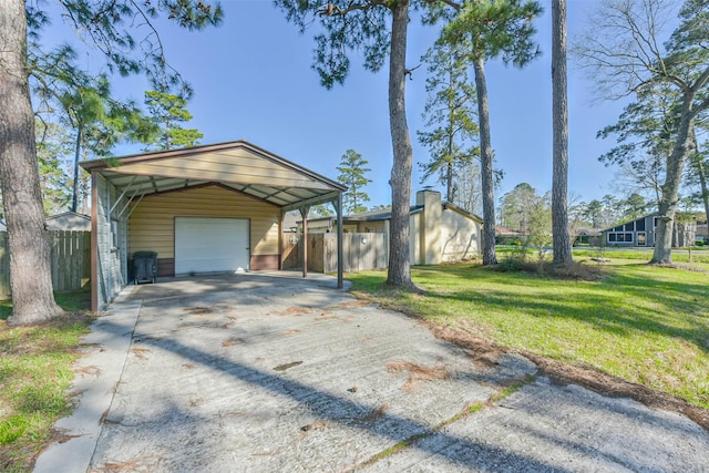 exterior space with an outbuilding, concrete driveway, a front lawn, and fence