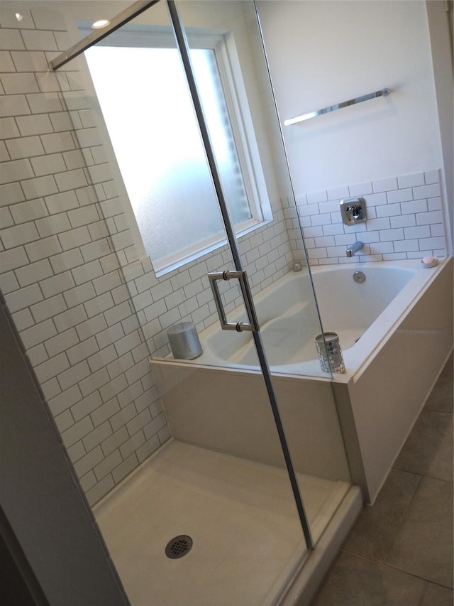 full bath featuring a garden tub, tile patterned floors, and a stall shower