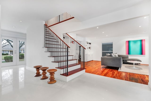 staircase with baseboards, french doors, and recessed lighting