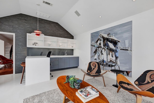 living room featuring lofted ceiling and visible vents