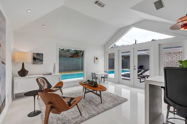 interior space with vaulted ceiling, french doors, visible vents, and a healthy amount of sunlight