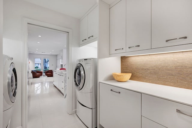 clothes washing area featuring recessed lighting, cabinet space, independent washer and dryer, and light tile patterned floors