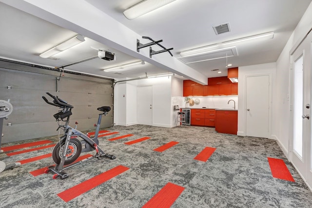 garage with a garage door opener and visible vents