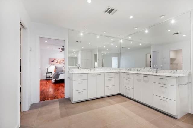 full bathroom with tile patterned flooring, recessed lighting, vanity, visible vents, and ensuite bath