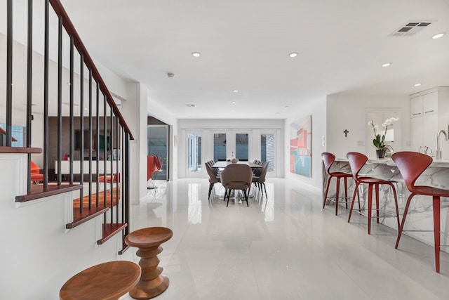 dining space featuring recessed lighting, french doors, visible vents, and stairs