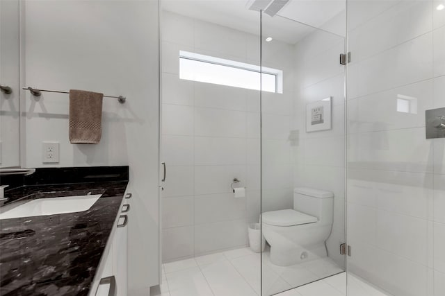 full bath featuring tile patterned flooring, vanity, toilet, and a shower stall