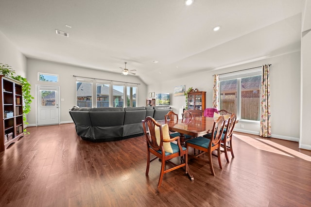 dining room with dark wood-style floors, plenty of natural light, visible vents, and vaulted ceiling